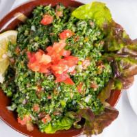 Tabbouli Salad · A tantalizing salad made of cracked wheat, ripe tomatoes, onions and parsley, with lemon and...