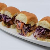4 Pulled Pork Sliders · Pork rubbed with a blend of spices, slow-cooked and smoked with natural hickory, mixed with ...