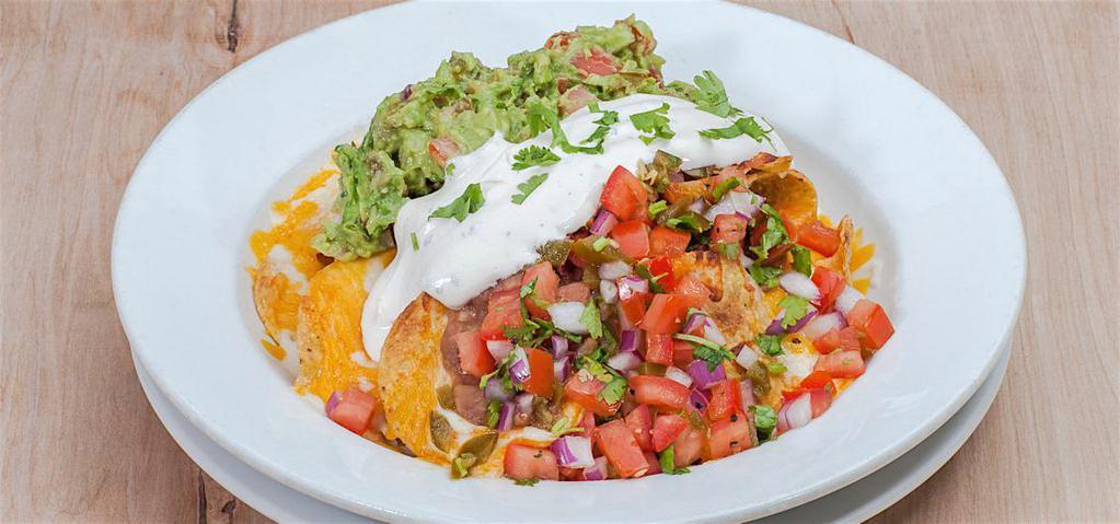 Nachos · Choice of chicken, asada, meat sauce. Melted cheese, pico de gallo, re-fried beans, sour cream and guacamole.