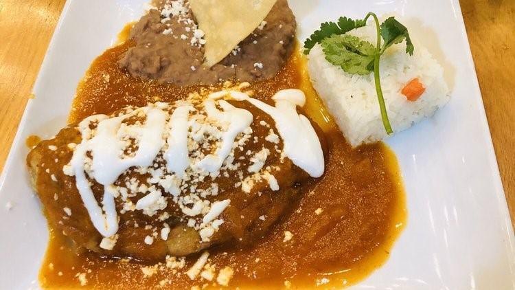 Chile Relleno De Queso · Roasted poblano pepper stuffed with queso fresco, dipped in egg batter then fried and topped with a memorable chile tomato sauce and sour cream.