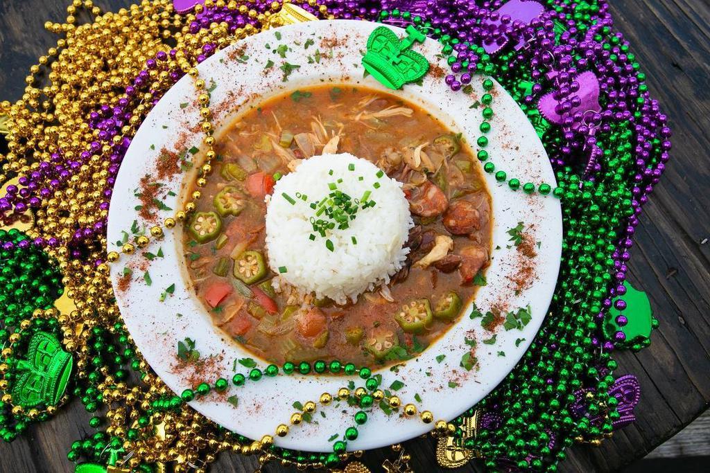 Gumbo · Traditional savory roux broth, cooked with shrimp, chicken, and andouille sausage. Served with garlic rice.