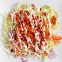 Chicken Over The Salad · Chicken over Lettuce with Yogurt Sauce, Sriracha, Tomatoes, & Onions.