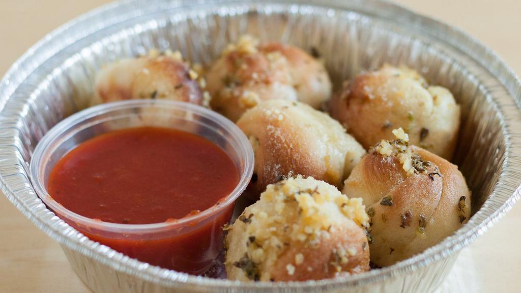 Garlic Knots · Delicious knots dipped in our secret garlic sauce.