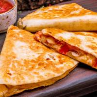 Classic Quesadilla · Flour tortilla stuffed with shredded cheese, choice of meat.