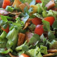 Fatoush Salad · Romaine lettuce, tomatos, cucumber, onion, and pita chips.