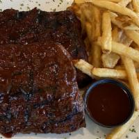 1/2 Rack Of Ribs · Tender baby back ribs basted w/ BBQ sauce. Served your choice of side. 772 cal.