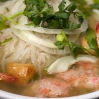 Seafood Noodle Pho (Phở Đồ Biển) · Shrimps, crab meat, fish ball, and squid. Served with a side of Thai basil, bean sprouts, an...
