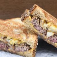 Patty Melt · Covered with sautéed onions and melted American cheese on grilled rye bread.