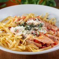 Seafood Pasta · Calamari, shrimp, salmon, tomatoes and fresh basil tossed in a garlic wine sauce. Sprinkled ...