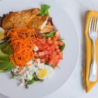 Chicken Cobb Salad · Bacon, hard boiled eggs, chopped tomatoes, avocado and crumbled bleu cheese on mixed greens....