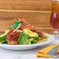 Southwest Bbq Chicken Salad · Deep fried chicken tenders tossed in BBQ sauce on a bed of romaine lettuce, avocado, tomatoe...