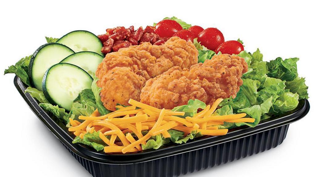 Chicken Club Salad (Crispy) · Iceberg and romaine lettuce blend topped with Crispy Chicken Strips, diced bacon, cucumber slices, grape tomatoes and shredded Cheddar cheese, served with Bacon Ranch dressing and seasoned croutons