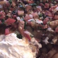 Carne Asada French Fries · Cheese, pico de gallo and sour cream on top.