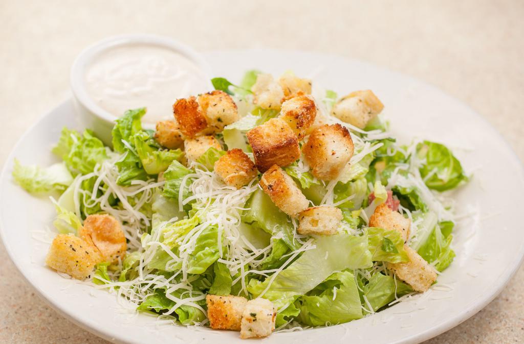 Caesar Salad · Romaine, garlic croutons, Parmesan cheese tossed with our Caesar dressing. Served with garlic bread. Add protein for an additional charge.