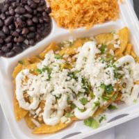 Chicken Chilaquiles  · Fried corn tortillas. Then sauteed with a mild green tomatillo salsa. Topped with onions, ci...