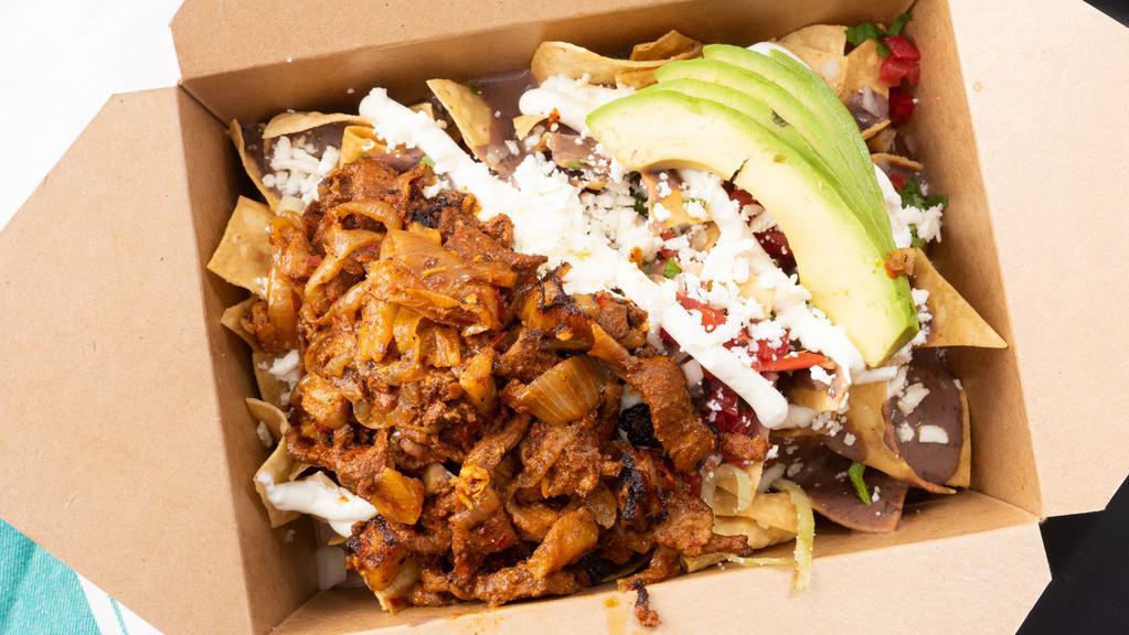 Pastor Mexican Fries · Pork marinated in adobo grilled with onion and pineapple. Fries topped with beans, onions, tomatoes, cilantro, sour cream, queso fresco, and avocado.