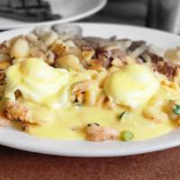 Seafood Royal Benedict · Grilled English muffin topped with sautéed lobster meat, Dungeness crab, shrimp, green onion...