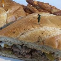 Philly Cheesesteak · Grilled green peppers and onions with thinly sliced NY steak. Topped with Swiss cheese.