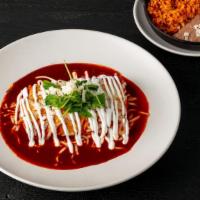 Braised Short Rib Enchiladas · Red guajillo chile sauce, melted jack cheese, frisee, Mexican red rice, beans.