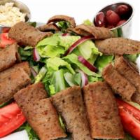 Gyro Greek Salad · Cut slices of Beef Lamb Gyro meat and placed on top of romaine, iceberg lettuce, tomato, oni...