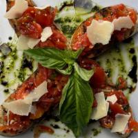 Bruschetta · Chopped tomatoes, basil, garlic, pesto sauce, olive oil on grilled rustic bread.