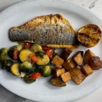 Branzino · Branzino fillet pan seared with extra virgin olive oil and grilled lemon wedge