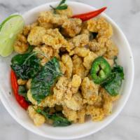 Crispy Popcorn Chicken · Chicken bites fried to perfect crispiness-seasoned with flavorful pepper mix and basil leaves.