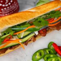 Grilled Pork Sandwich · Caramelized, juicy, right-off-the-grill pork on toasted French baguette dressed with pâté, m...