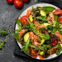Salmon Salad · Salmon over a fresh bed of mixed greens and your choice of dressing