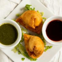 Samosa · Fried pastry dough stuffed with spiced potatoes & peas fried golden brown