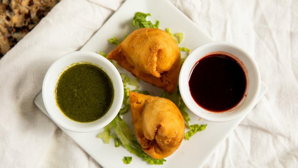 Samosa · Fried pastry dough stuffed with spiced potatoes & peas fried golden brown