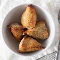 Bikaneri Samosa · Golden fried flaky pastry puffs filled with potatoes, green peas, and spices.