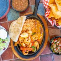 Fajitas · Served with Spanish rice, refried beans with melted cheese & guacamole.
Choice of Shrimp or ...