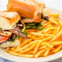 Chicken Breast Sandwich · Soft French roll with bacon, avocado, tomato, greens, mozzarella and ranch, served with Fren...