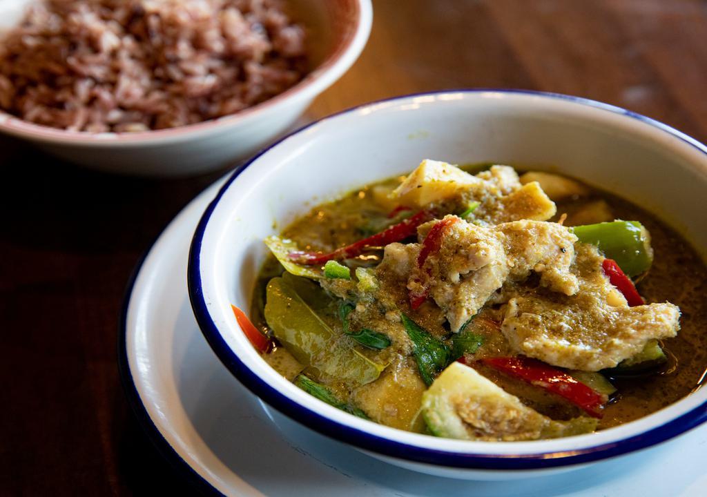Green Curry · Thai style spicy curry with green Thai chiles, shrimp paste, kaffir lime, coconut milk, Thai eggplant, bamboo shoots, red peppers, and sweet basil.