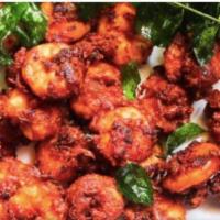 Shrimp 65 · Shrimp marinated in spicy masala and deep fried, garnished with onion and lemon wedges.