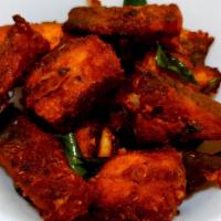 Fish 65 · Cubes of fish marinated in spicy masala and deep fried. Garnished with onion and lemon wedges.