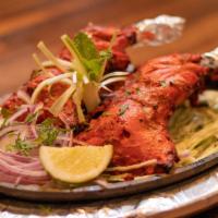 Tandoori Chicken · Marinated chicken(2 leg quarters) cooked in a clay oven served with mint sauce.