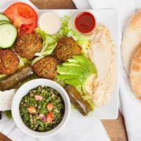 Super Falafel Plate · A delicious mixture of garbenzo beans, herbs, and spices, served with tahini, lettuce, tomat...