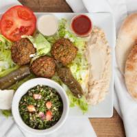 Falafel Delight Plate · A delicious mixture of garbanzo beans, herbs, and spices, served with tahini, lettuce, tomat...