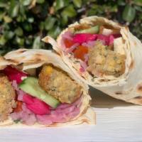The Falafel · Hummus, falafel, heirloom tomato and parsley salsa, tahini, pickled red onion and turnips wr...
