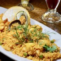 Arroz Con Mariscos · Rice simmered in saffron wine sauce with squid, mussels, shrimp, octopus and scallops.