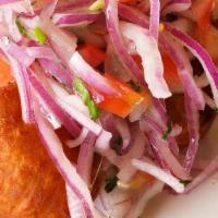 Papa Rellena · Potato croquettes stuffed with beef picadillo served with salsa criolla and huancaina sauce.