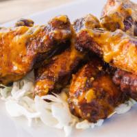 Smoked Wings · Tossed in your choice of buffalo or bbq sauce, house-made ranch.