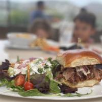 Pulled Pork  · Smoked pork shoulder, apple cider vinaigrette coleslaw, bbq sauce, brioche bun.