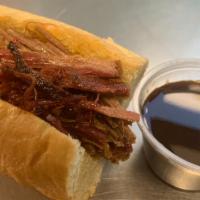 Smoked Pulled Bbq Brisket · 1/2 lb of pulled brisket, smoked whole and served hot on a Hoagie roll - comes with pickle a...