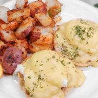 Eggs Benedict · Toasted English muffin topped with ham, poached eggs, and hollandaise sauce.