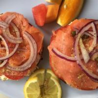 Lox & Bagel · Smoked salmon, cream cheese, tomato, capers, onion, lemon pepper on a combo bagel.