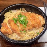 Chicken Katsu Donburi · Bowl of white rice topped with stir-fried onion & cabbage in dashi-infused, soft-scrambled e...