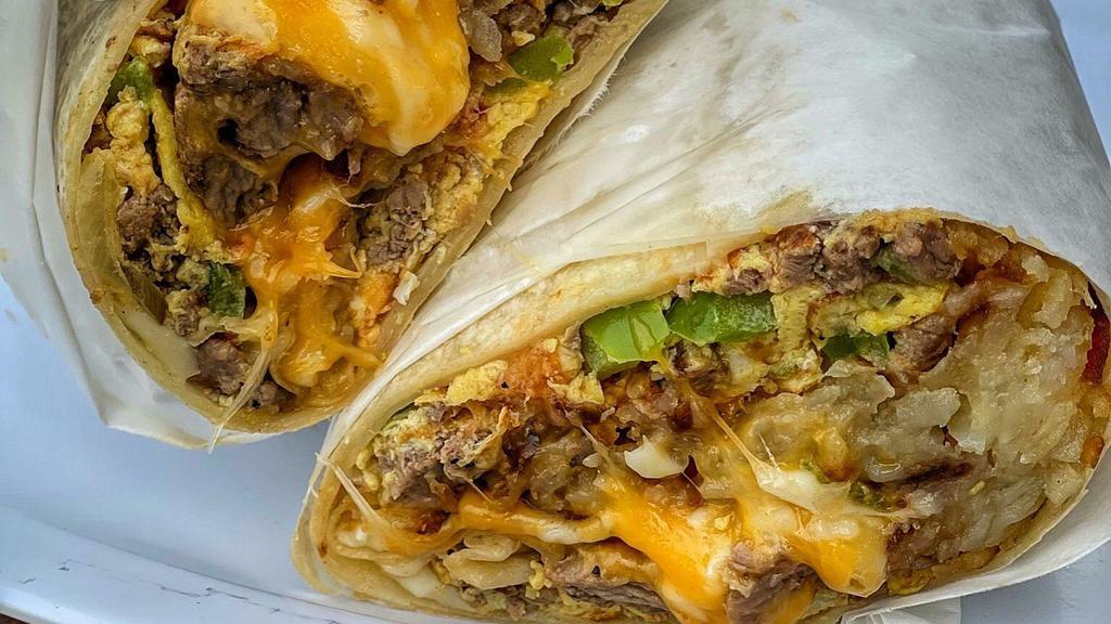 Machaca (Asada) Burrito · Machaca is made carne asada mixed with onions, bell pepper & tomato with 3 fresh eggs, hashbrowns, cheese and salsa on the side.